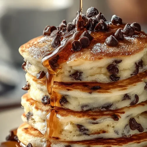 chocolate chip pancakes stacked with syrup and chocolate chips